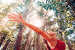 © C.Castilla - Peace and healthy concept.Woman with open arms in nature landscape.Sunlight and trees