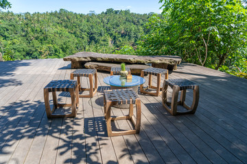 Wall Mural - Wooden table and chairs in empty tropical cafe next to rice terraces in island Bali, Indonesia