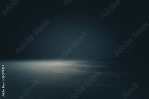 Abstract spacious place with dark wall, granular floor and spot light from ab...