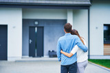 Fototapeta  - Couple in front of one-family house in modern residential area