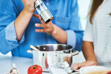 Wall Mural - Adult couple cooking together at home