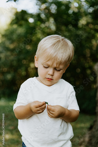 Adorable Cute Little Blond Hair Blue Eyed Kid Boy In White Tee