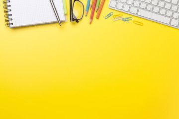Office yellow backdrop with supplies and computer