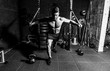 © Srdjan - Young strong focused fit muscular man chest bench press stretching workout training in the gym with rubber for strength and good looking of muscles dark image real people training selective focus