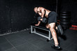© Srdjan - Young sweaty fit muscular strong man doing cross workout training back muscles with dumbbell on the bench in the gym dark image real people