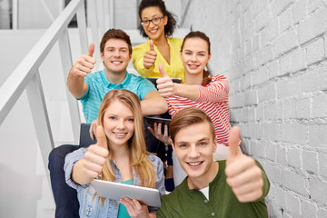 Poster - education, technology and learning concept - group of happy international high school students or classmates with tablet pc computers sitting on stairs