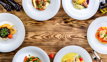 Wall Mural - dishes in plates on a wooden table copyspace