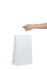 Wall Mural - Female hand holding shopping bag on white background