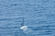 Real periscope and radio transmission mast of the attack submarine  during the submarine sails in the periscope depth in the sea