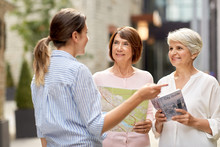Tourism, Travel And Friendship Concept - Female Passerby Showing Direction To Senior Women With City Guide And Map On Tallinn Street