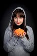 © Elena - Beautiful girl with pumpkin in hands on black isolated background
