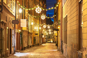 Sticker - Street in Old Town (Gamla Stan) decorated for Christmas time at night, Stockholm, Sweden