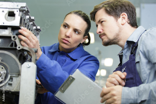 Fotografía couple of technicians checking an engine machine