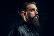 © Fxquadro - Portrait of hopeless bearded man with hairstyle on the black background.