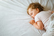© kaloriya - Cute baby girl sleeping on her tummy without pillow, free space