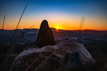 Silhouette Of A Woman Sitting On A Rock At Sunset, Stellenbosch, Western Cape, South Africa
