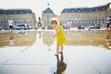 Toddler Girl Having Fun Famous Outdoor Water Fountain (Miroir D'eau) In Bordeaux