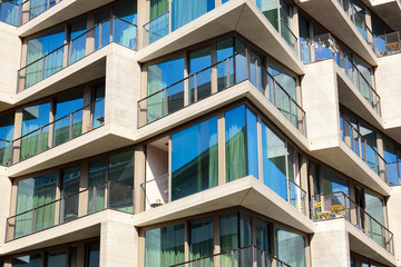 Detail of a modern apartment building with floor-to-ceiling windows seen in Berlin, Germany