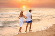 © New Africa - Young couple having fun on beach at sunset