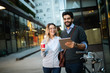 © NDABCREATIVITY - Beautiful young couple walking down the street with tablet