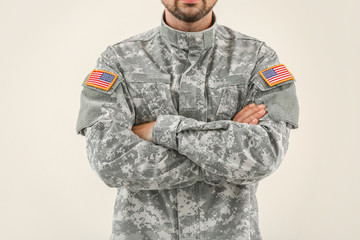 Wall Mural - Soldier in camouflage on light background