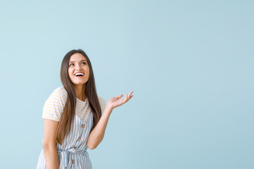 Poster - Portrait of happy young woman on color background