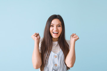 Poster - Portrait of happy young woman on color background