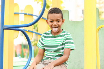 Wall Mural - Cute little African-American boy on playground
