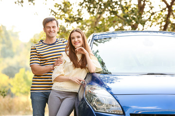 Poster - Happy couple near their new car outdoors