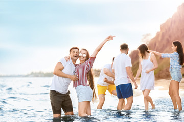 Poster - Happy friends on sea beach at resort