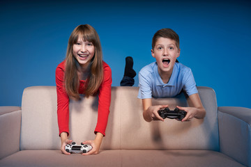 Wall Mural - Computer game competition. Gaming concept. Excited girl playing video game with joystick