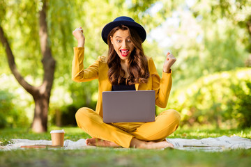 Sticker - Portrait of her she nice-looking attractive lovely charming pretty cheerful cheery ecstatic glad wavy-haired girl sitting in lotus pose using digital laptop celebrating winning on fresh air outdoors