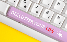 Writing Note Showing De Clutter Your Life. Business Concept For Remove Unnecessary Items From Untidy Or Overcrowded Places White Pc Keyboard With Note Paper Above The White Background