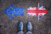 Brexit, Flags Of The United Kingdom And The European Union On Asphalt Road With Legs