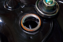 Open Fuel Tank Door On A Motorcycle And A Cap.
