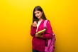 © luismolinero - Teenager student girl on vibrant yellow background presenting and inviting to come