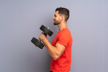 Wall Mural - Young sport man making weightlifting