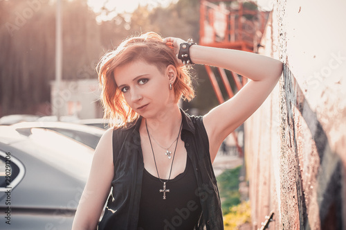 Punk Rock Young Red Haired Girl Outdoors In The Sunset And Looking