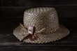© Grigoriy - Straw hat on a wooden table.