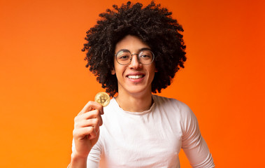 Poster - Cheerful millennial black guy holding golden bitcoin