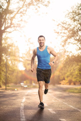 Canvas Print - Young fit man running outdoors