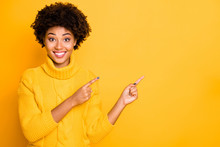 Closeup Photo Of Dark Skin Sales Lady Indicating Fingers Empty Space Wear Warm Knitted Pullover Isolated Yellow Color Background