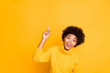 Photo Of Dark Skin Funny Lady Indicating Finger Up Empty Space On Sale Placard Wear Warm Knitted Jumper Isolated Yellow Background