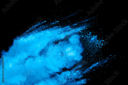Blue powder explode cloud on black background. Launched blue dust particles s...