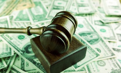 Wall Mural - Wooden gavel on banknotes on table, on  background