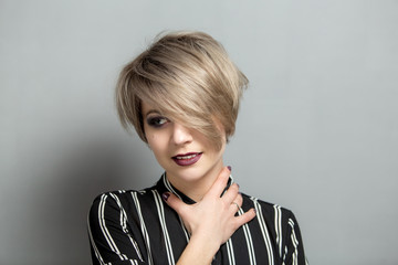 Portrait of young beautiful blonde woman with short hair