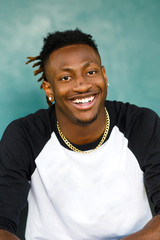 Wall Mural - happy African-American Teen Teenager male Man outside in a baseball jersey henley