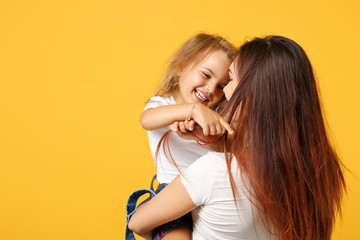 Wall Mural - Woman in light clothes have fun with cute child baby girl 4-5 years old. Mommy little kid daughter isolated on yellow background studio portrait. Mother's Day love family parenthood childhood concept.