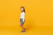 © ViDi Studio - Little cute child kid baby girl 4-5 years old wearing light denim clothes isolated on pastel yellow wall background, children studio portrait. Mother's Day, love family, parenthood childhood concept.