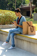 © Bisual Studio/Stocksy - Asiatic woman resting in a park with shopping bags